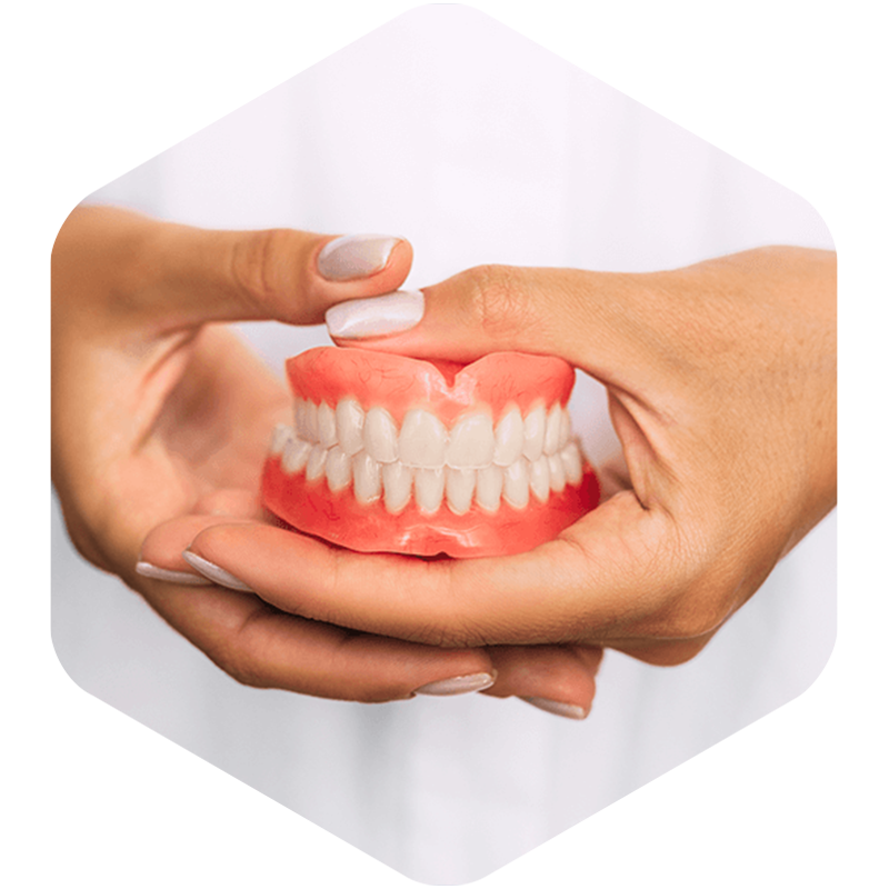 Dentist holding patient's dentures